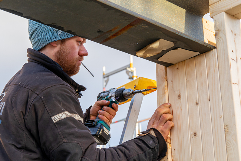 Håndverker på byggeplass og i arbeid med et prosjekt.
